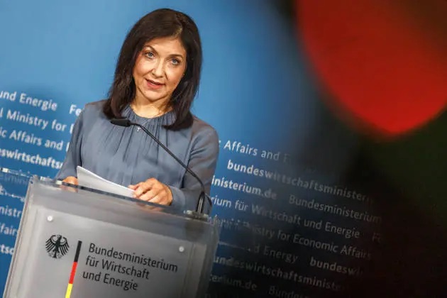 Katherina Reiche speaking at a lectern bearing the logo of the Federal Ministry for Economic Affairs and Energy