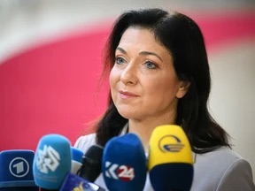 Katherina Reiche facing a cluster of broadcaster microphones